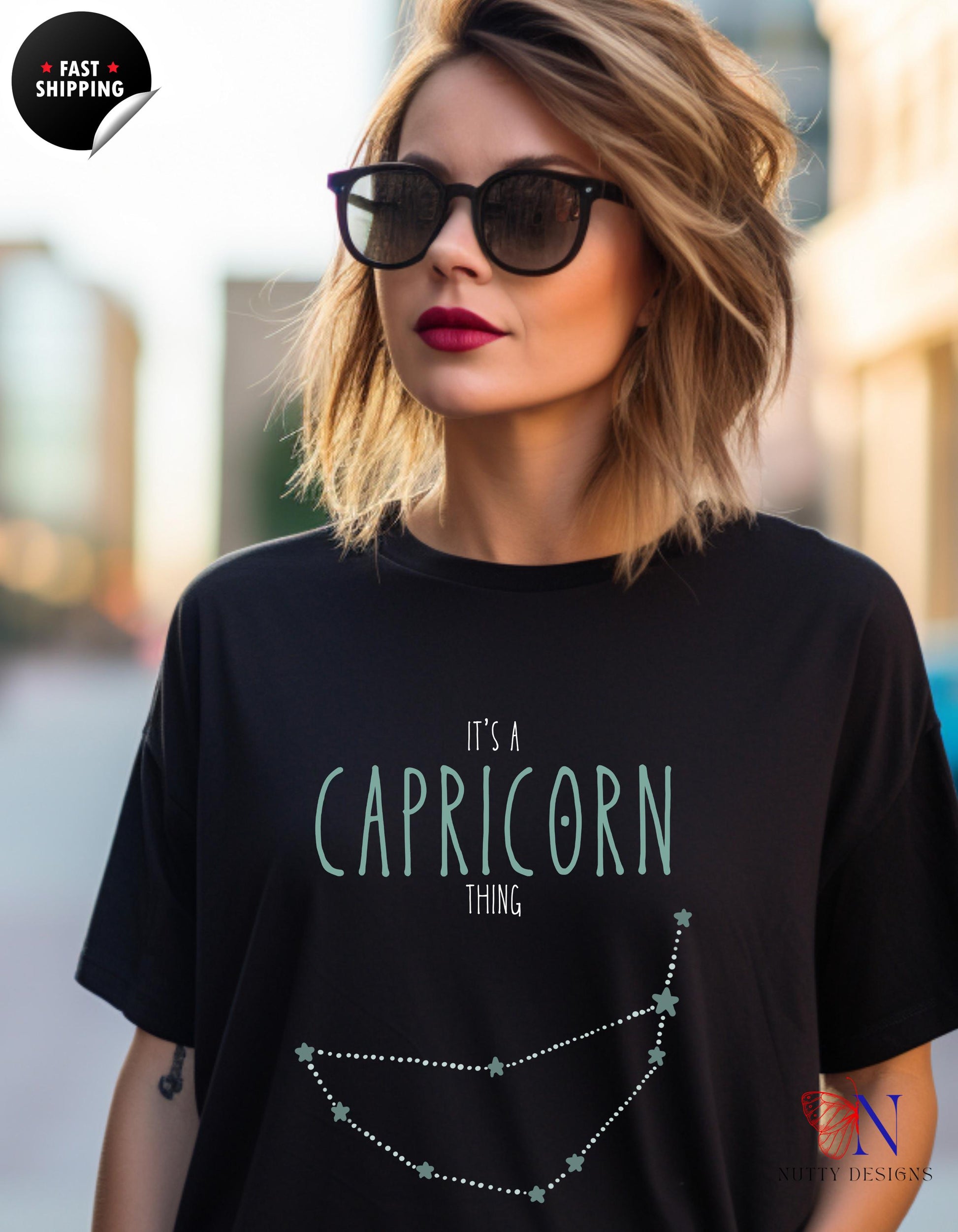 a woman wearing a black t - shirt that says it&#39;s a capric