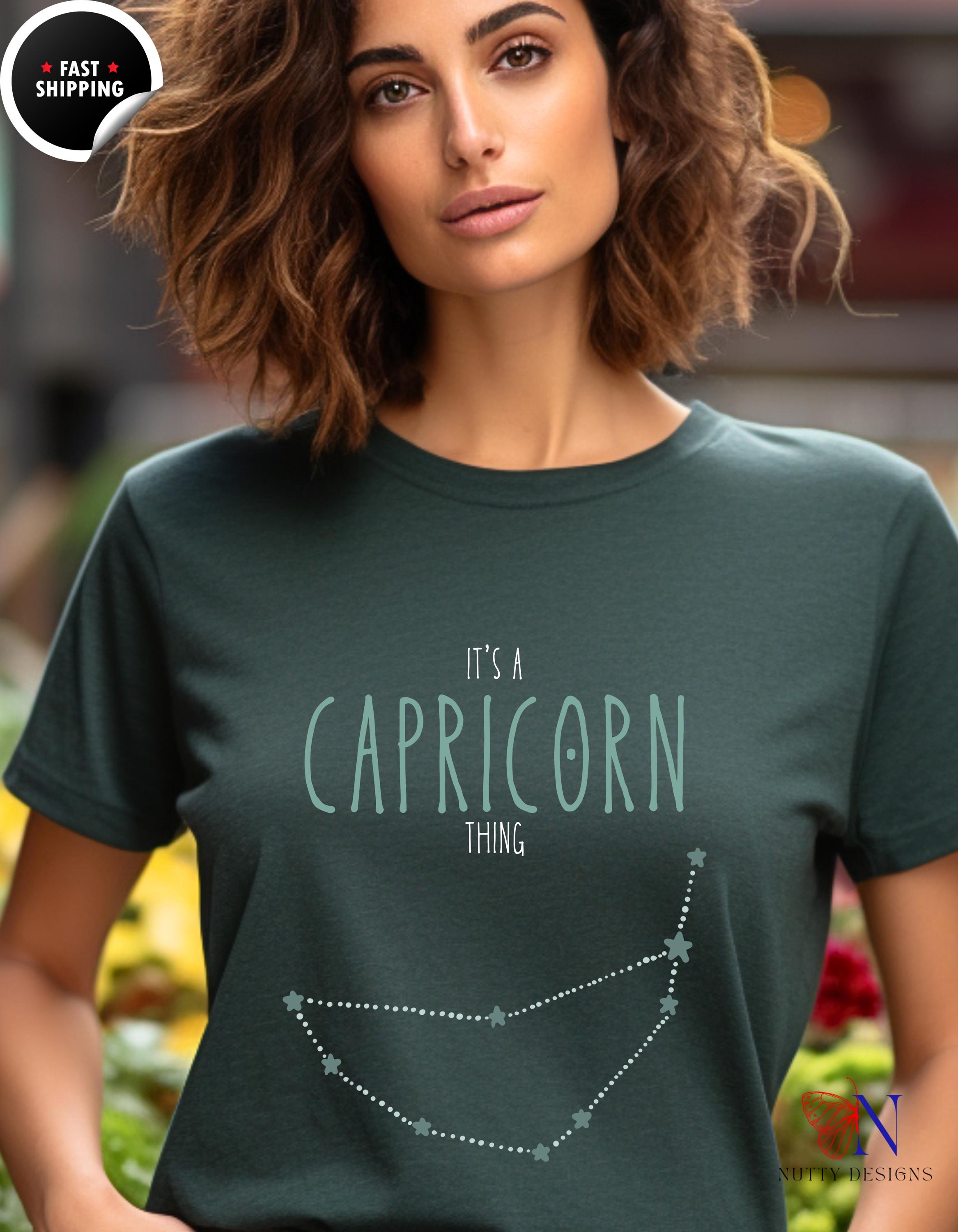 a woman wearing a t - shirt that says it&#39;s a capricon