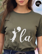 a woman wearing a t - shirt with the word la on it