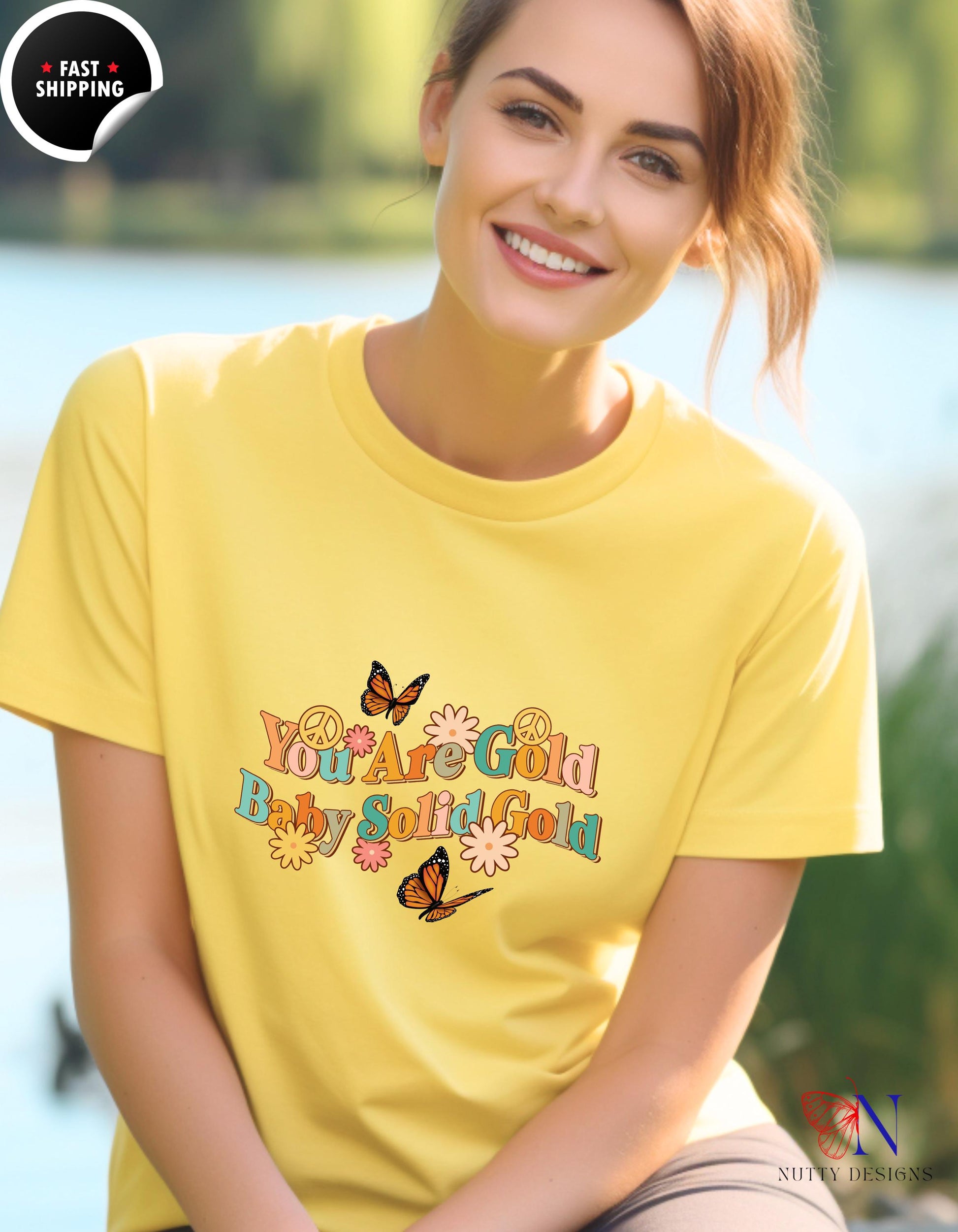 a woman wearing a yellow shirt with a butterfly on it