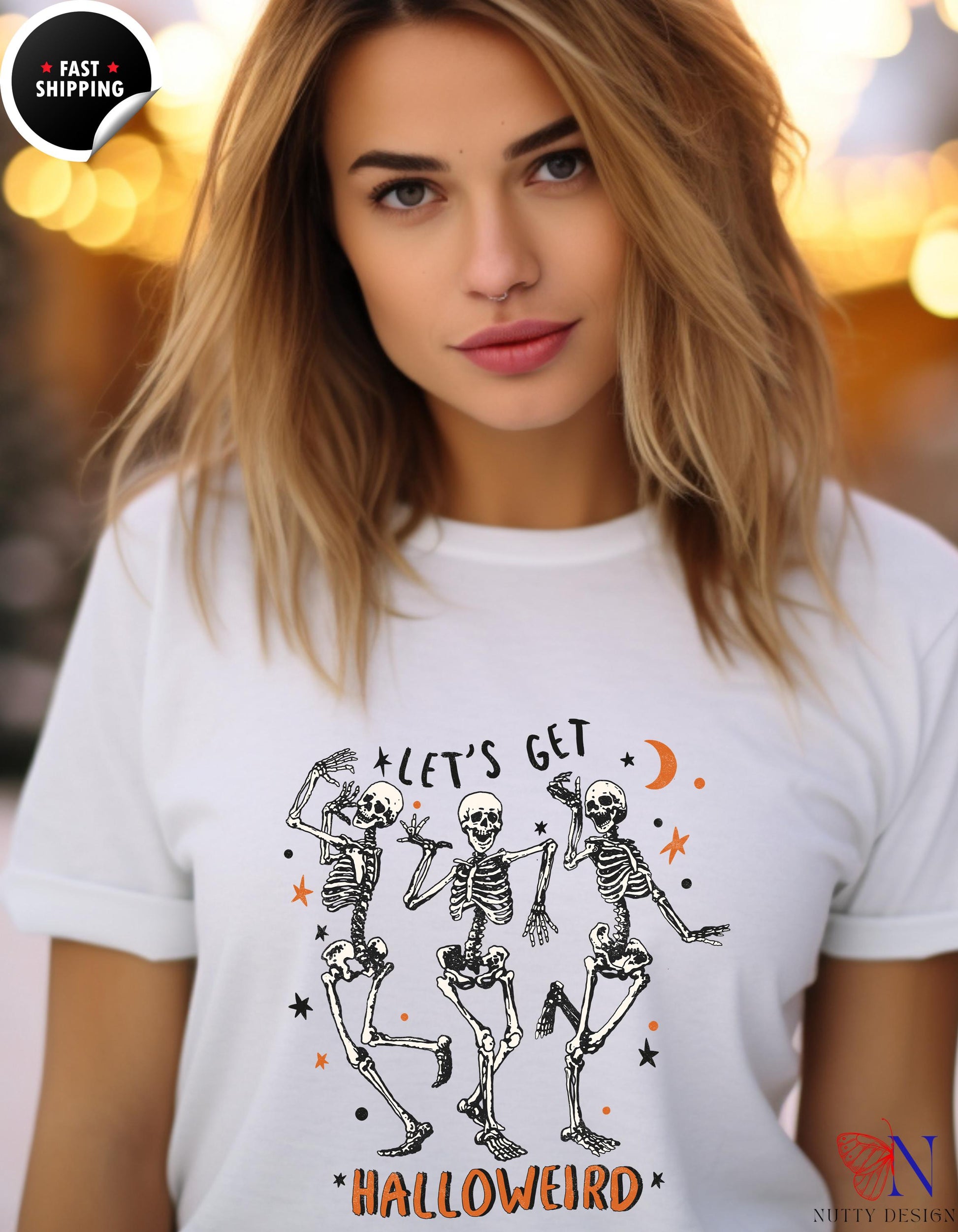 a woman wearing a white t - shirt with skeletons on it