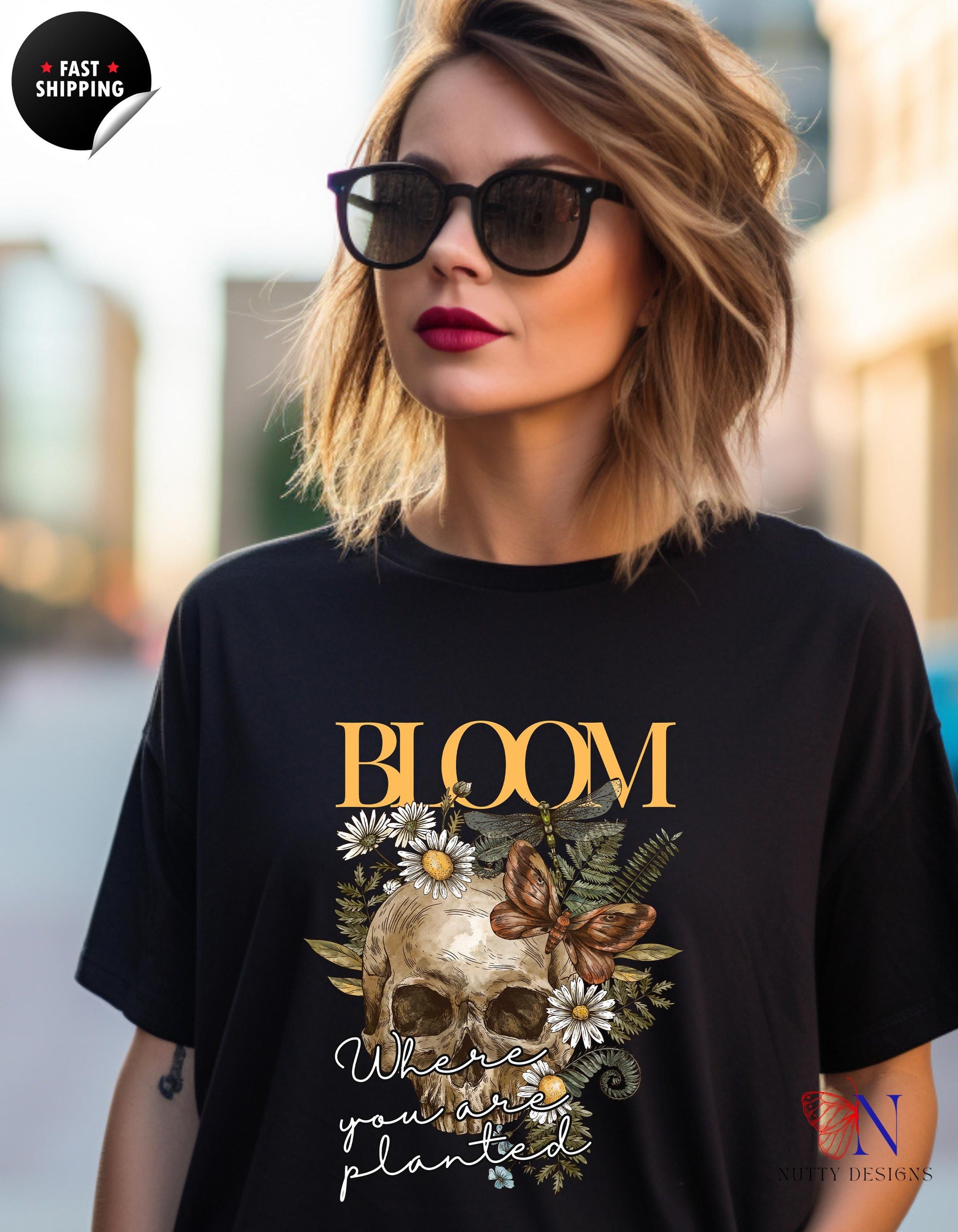 a woman wearing a t - shirt with a skull on it