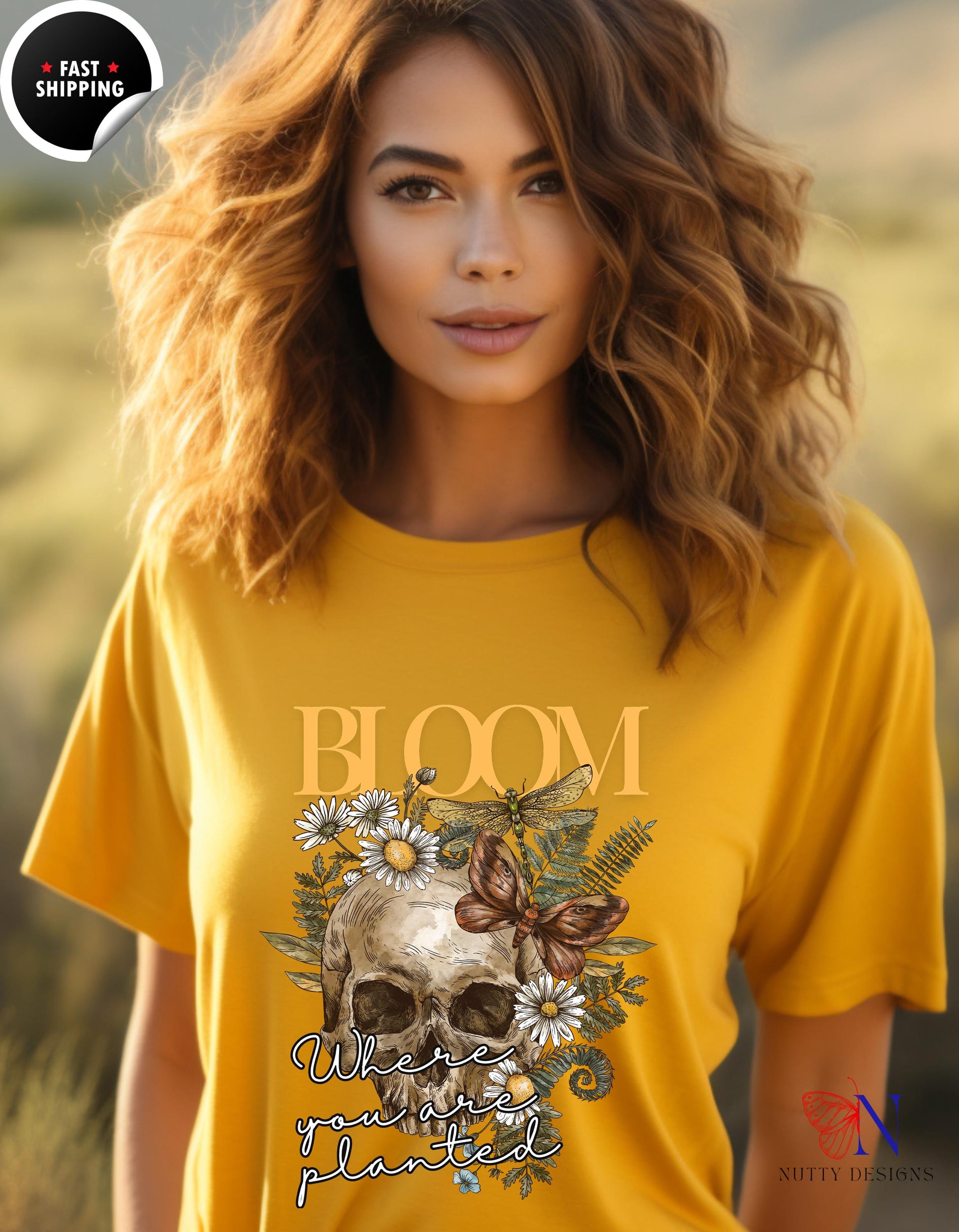 a woman wearing a yellow shirt with a skull and flowers on it