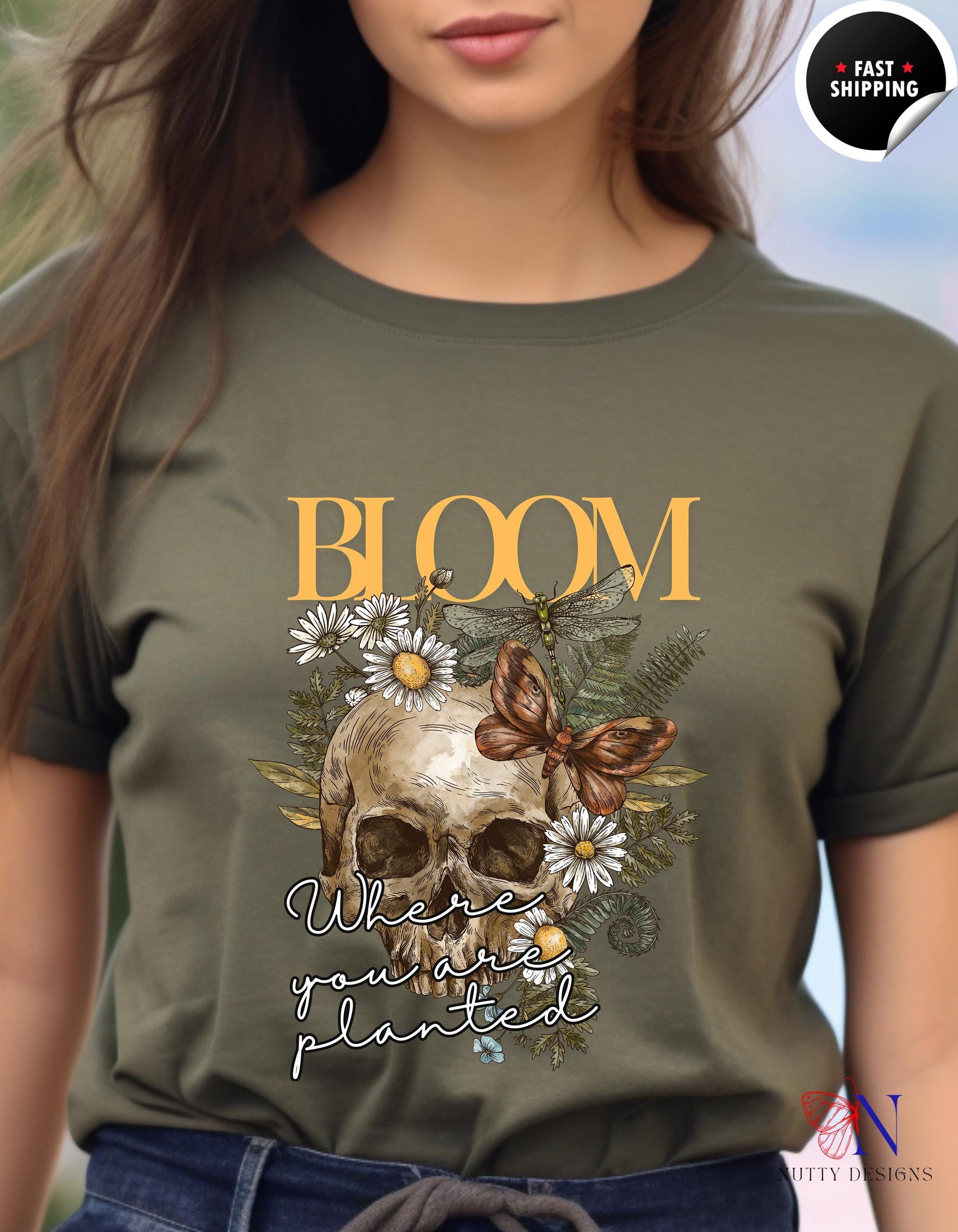 a woman wearing a t - shirt with a skull and flowers on it