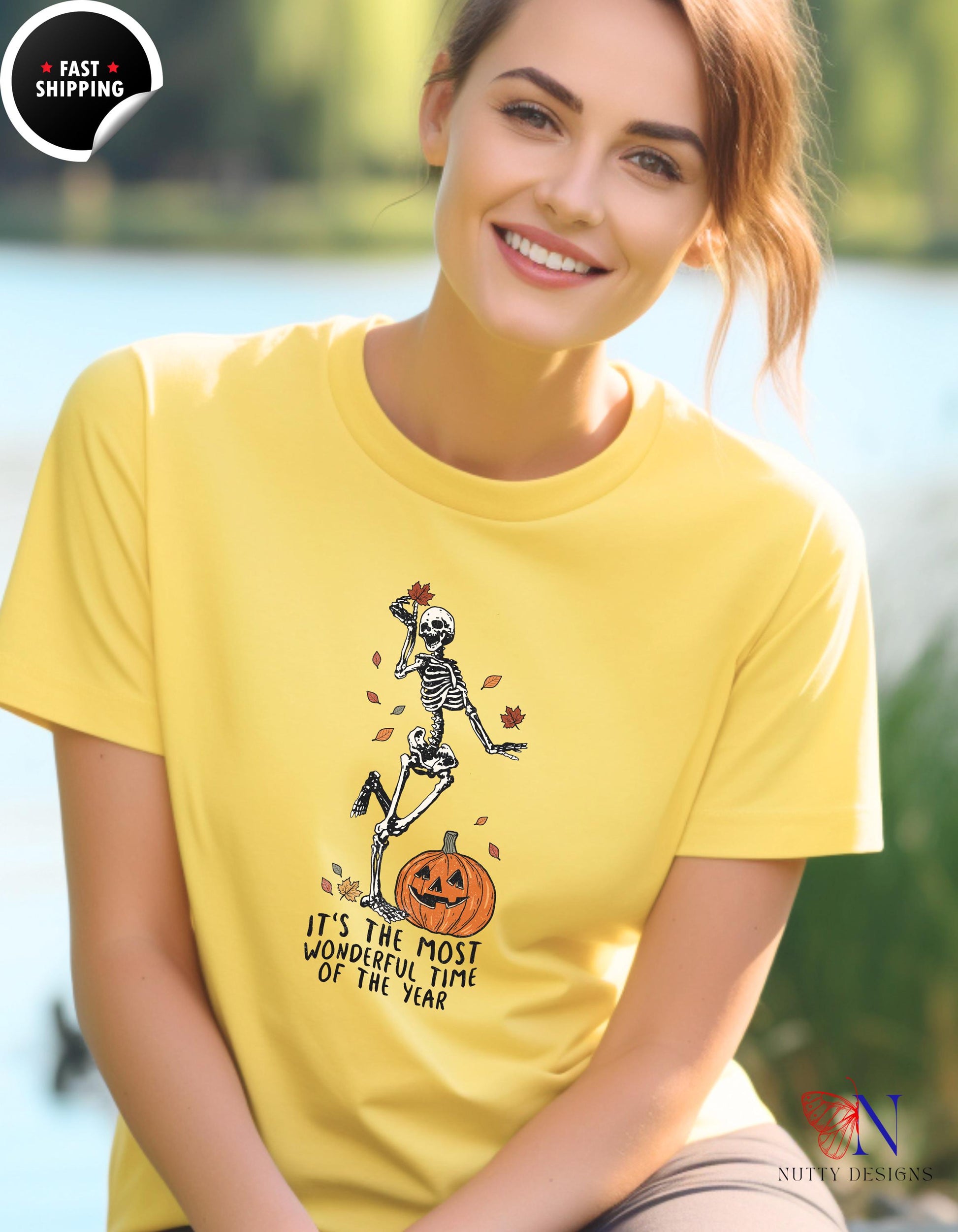 a woman wearing a yellow shirt with a skeleton on it