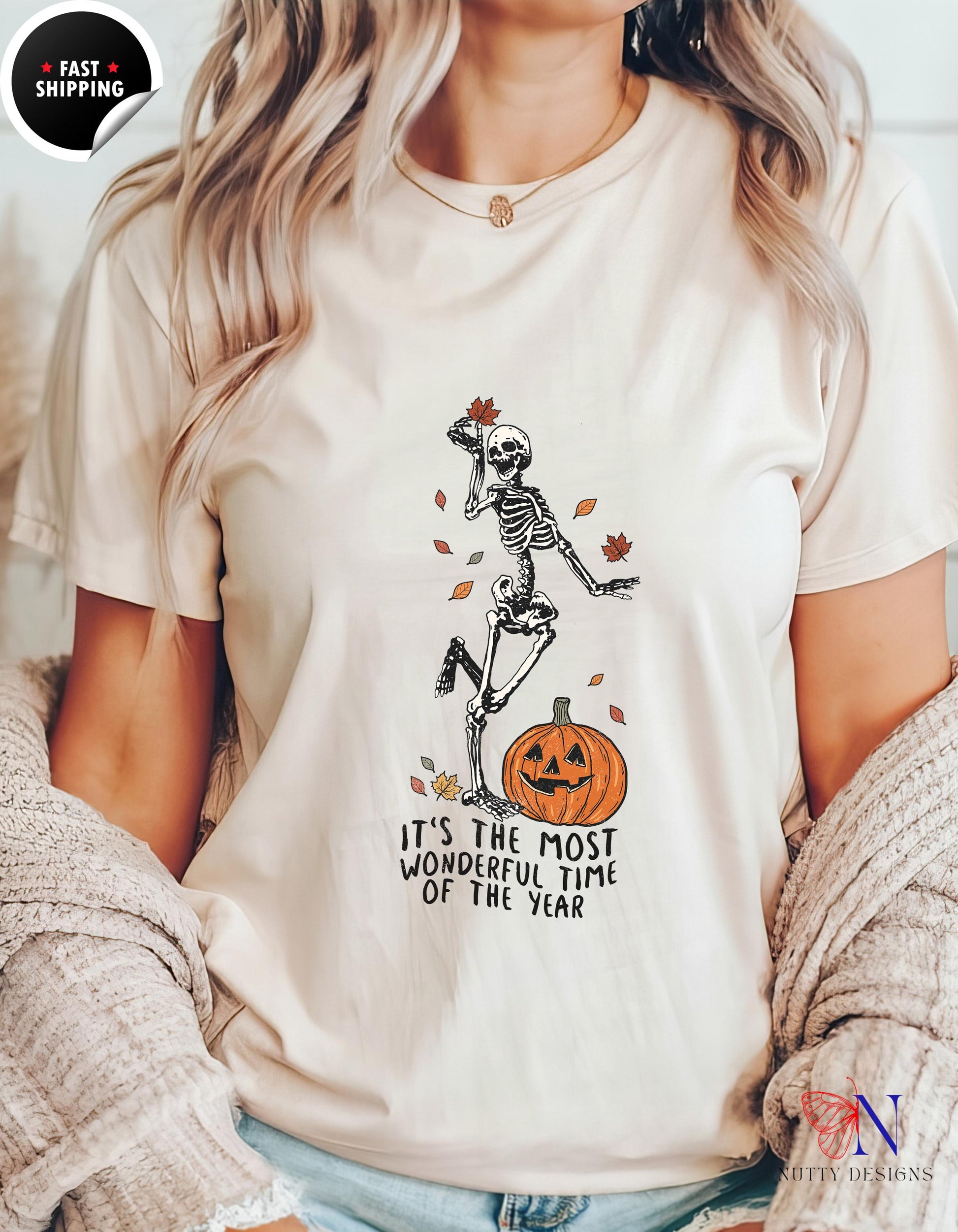 a woman wearing a white shirt with a skeleton on it