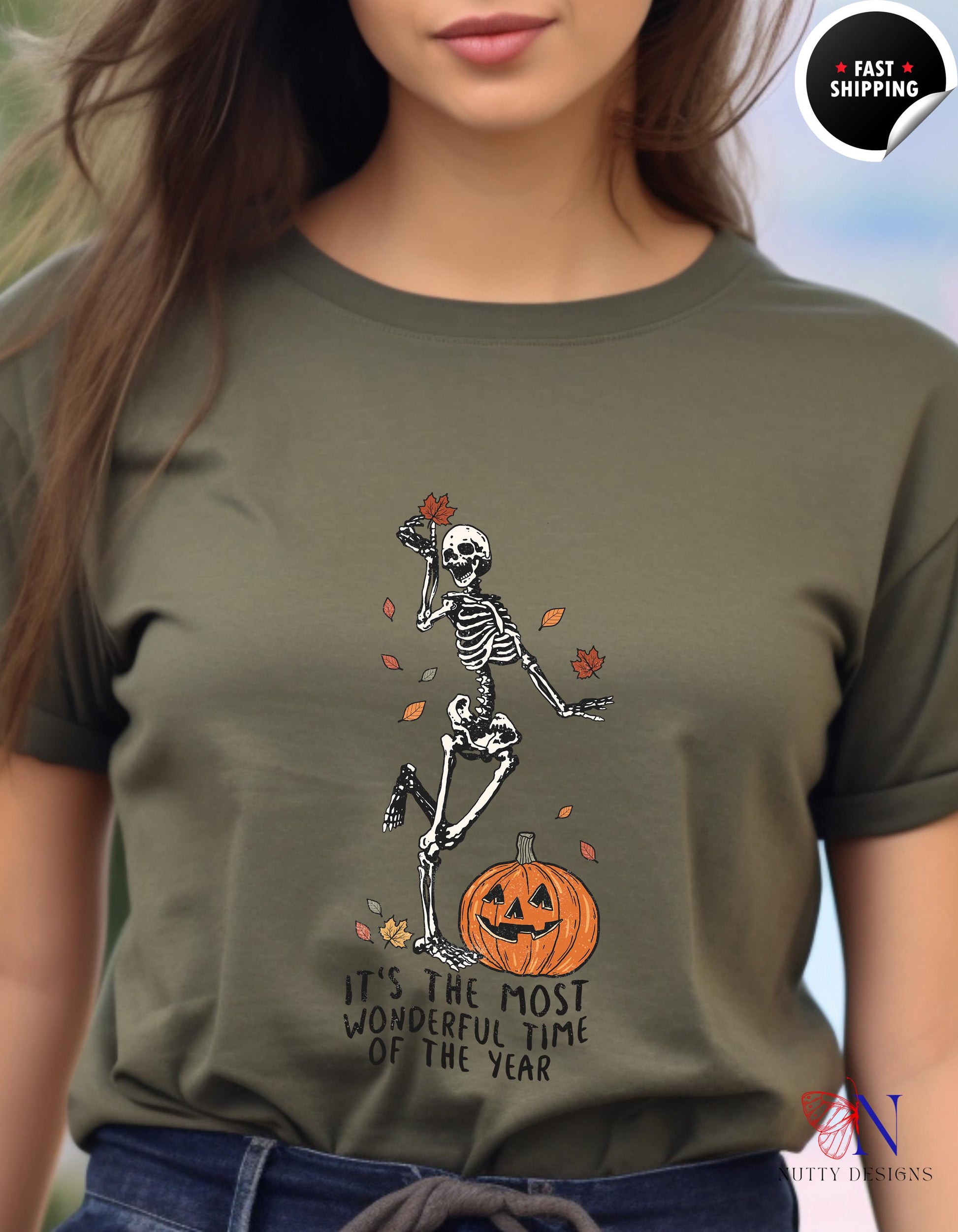 a woman wearing a t - shirt with a skeleton on it