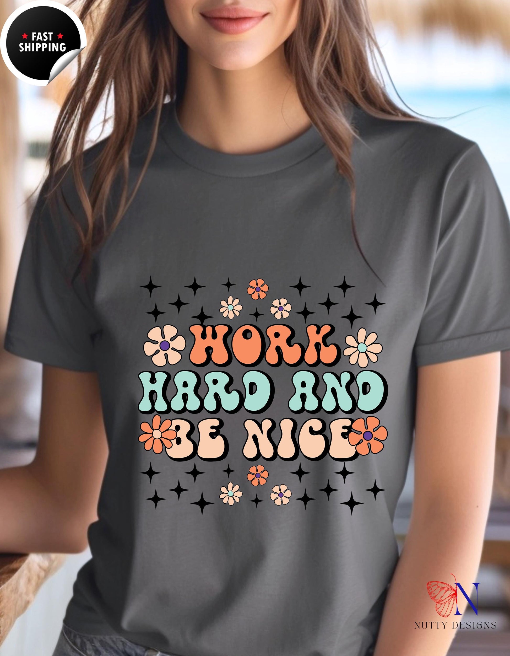 a woman wearing a t - shirt that says work hard and be nice