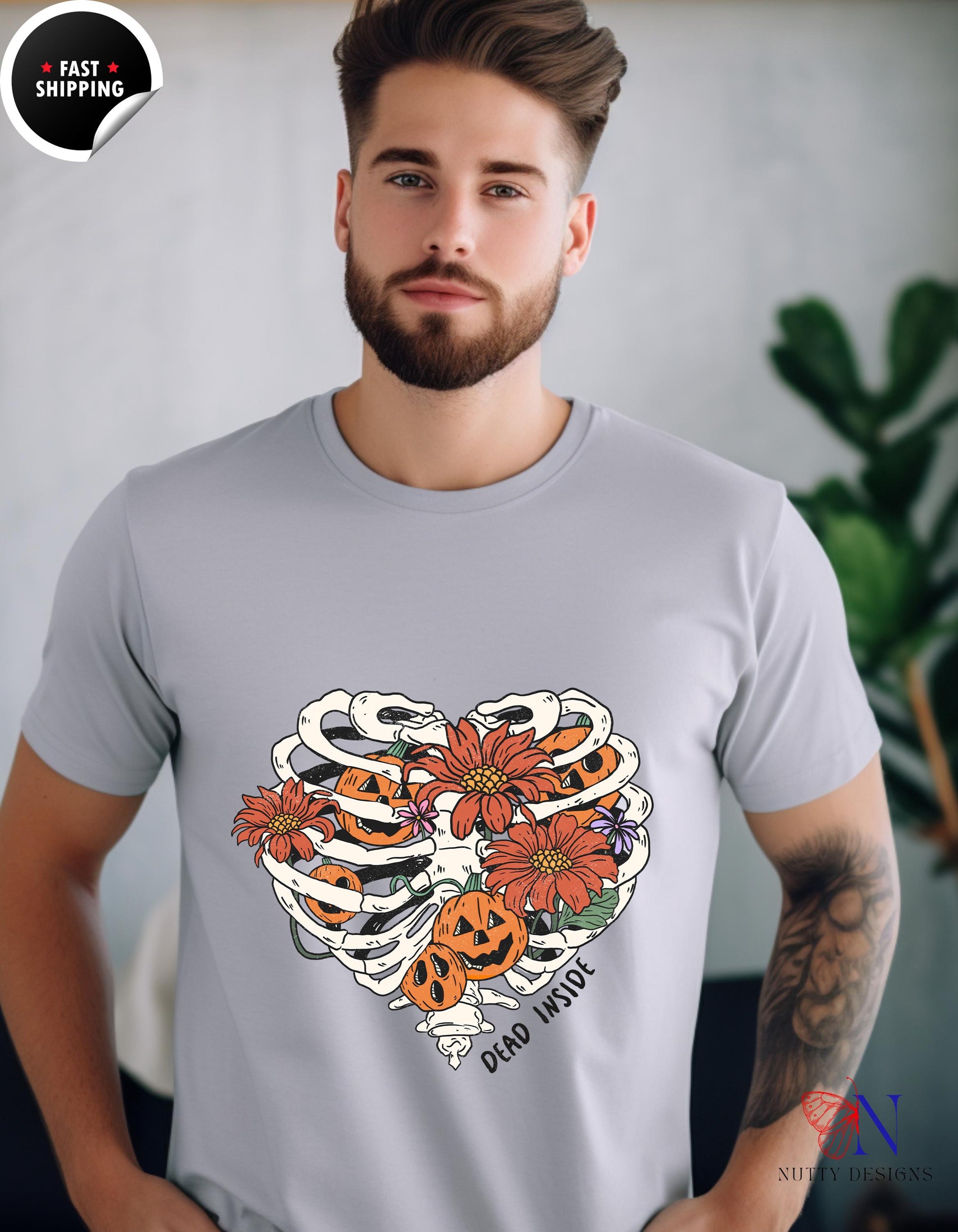 a man with a beard wearing a t - shirt with a skeleton and flowers on