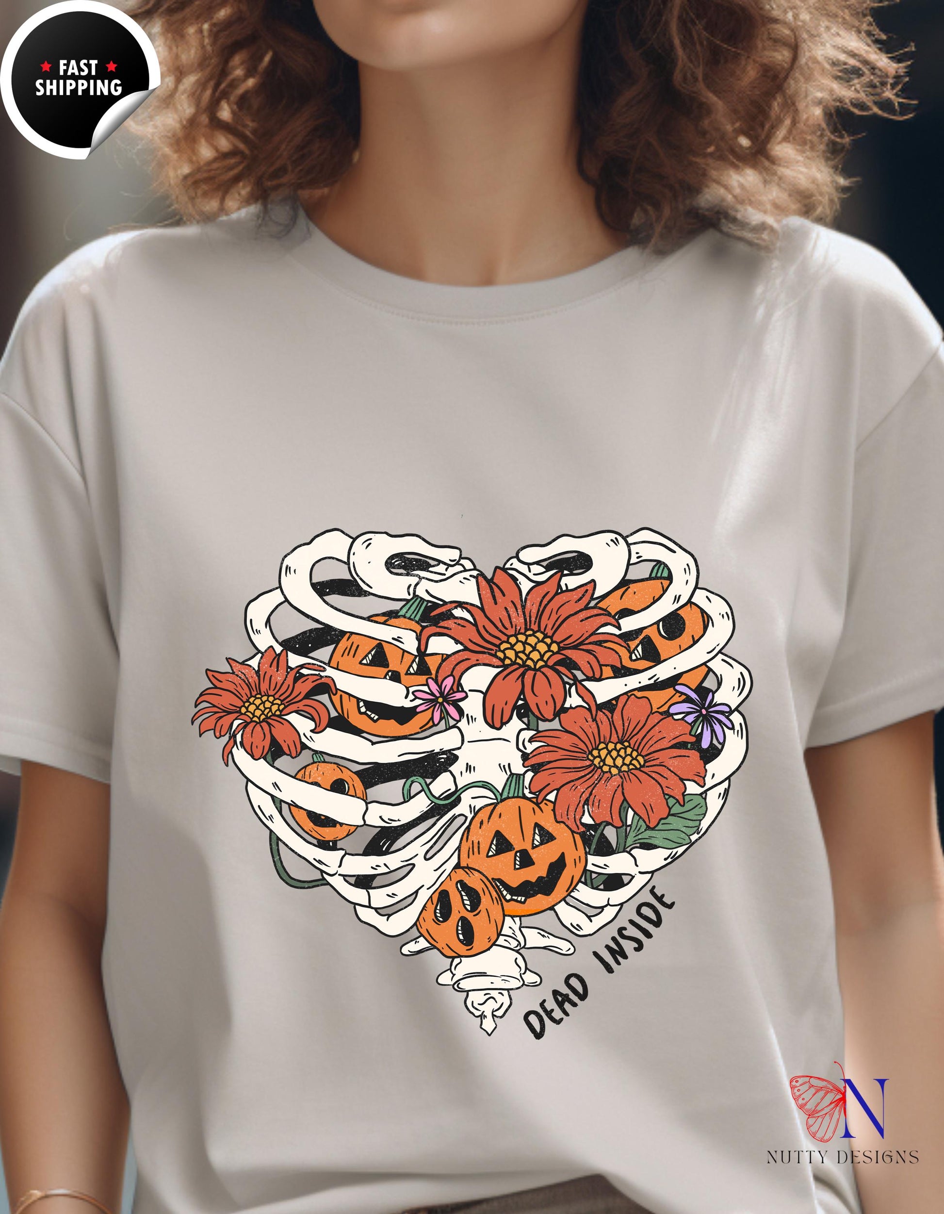 a woman wearing a t - shirt with a skeleton and flowers on it