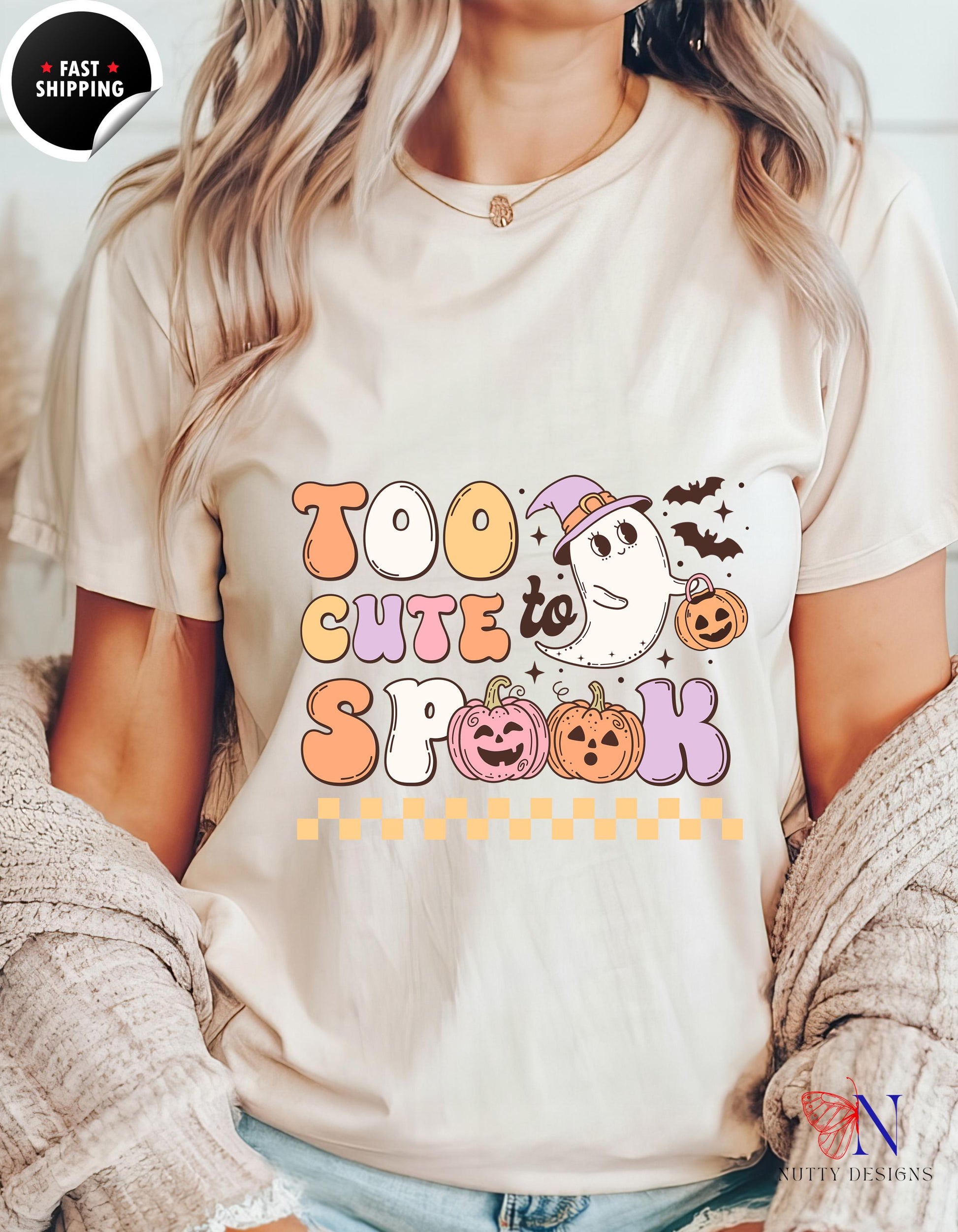 a woman wearing a t - shirt that says too cute to spook