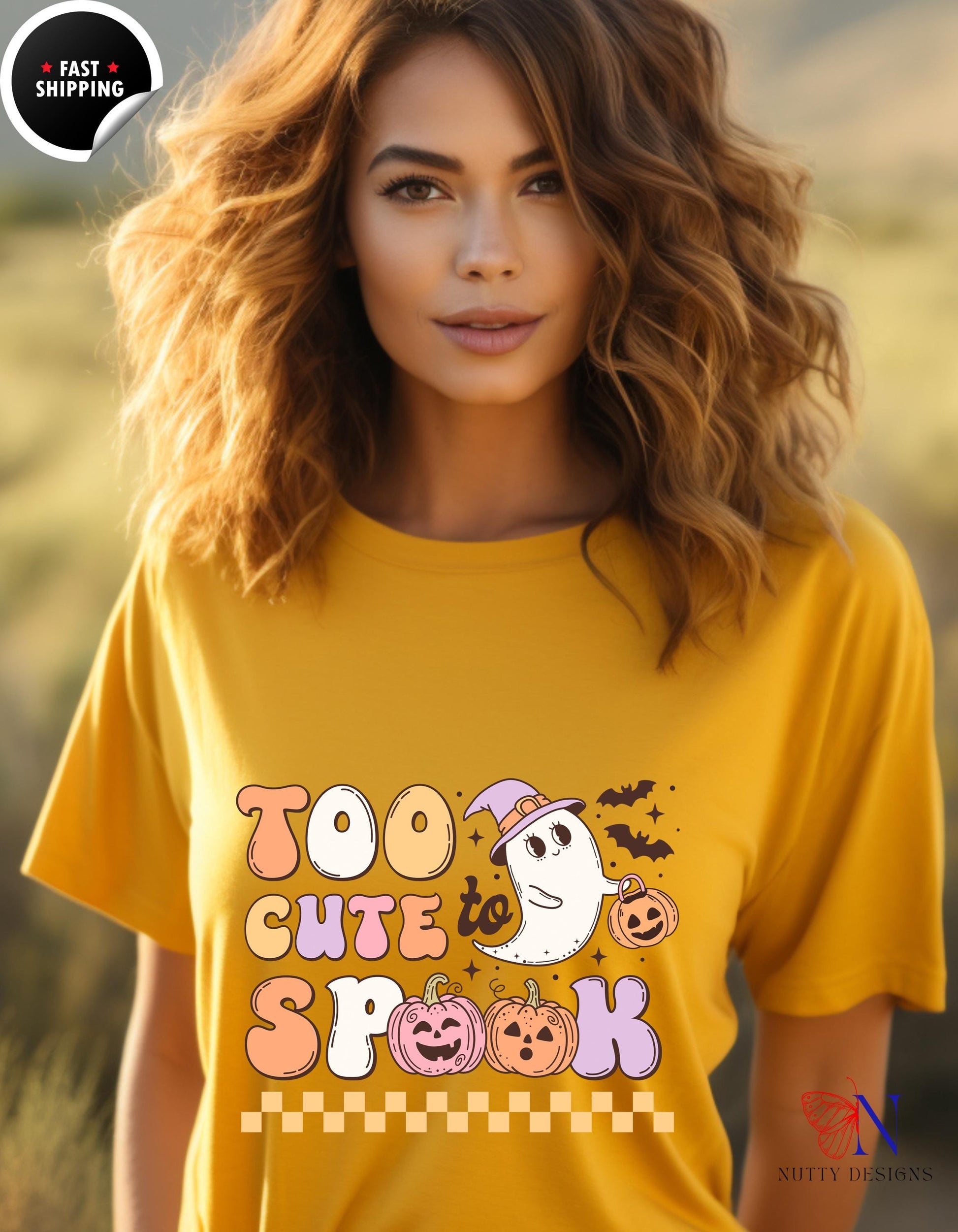 a woman wearing a yellow shirt with a ghost on it