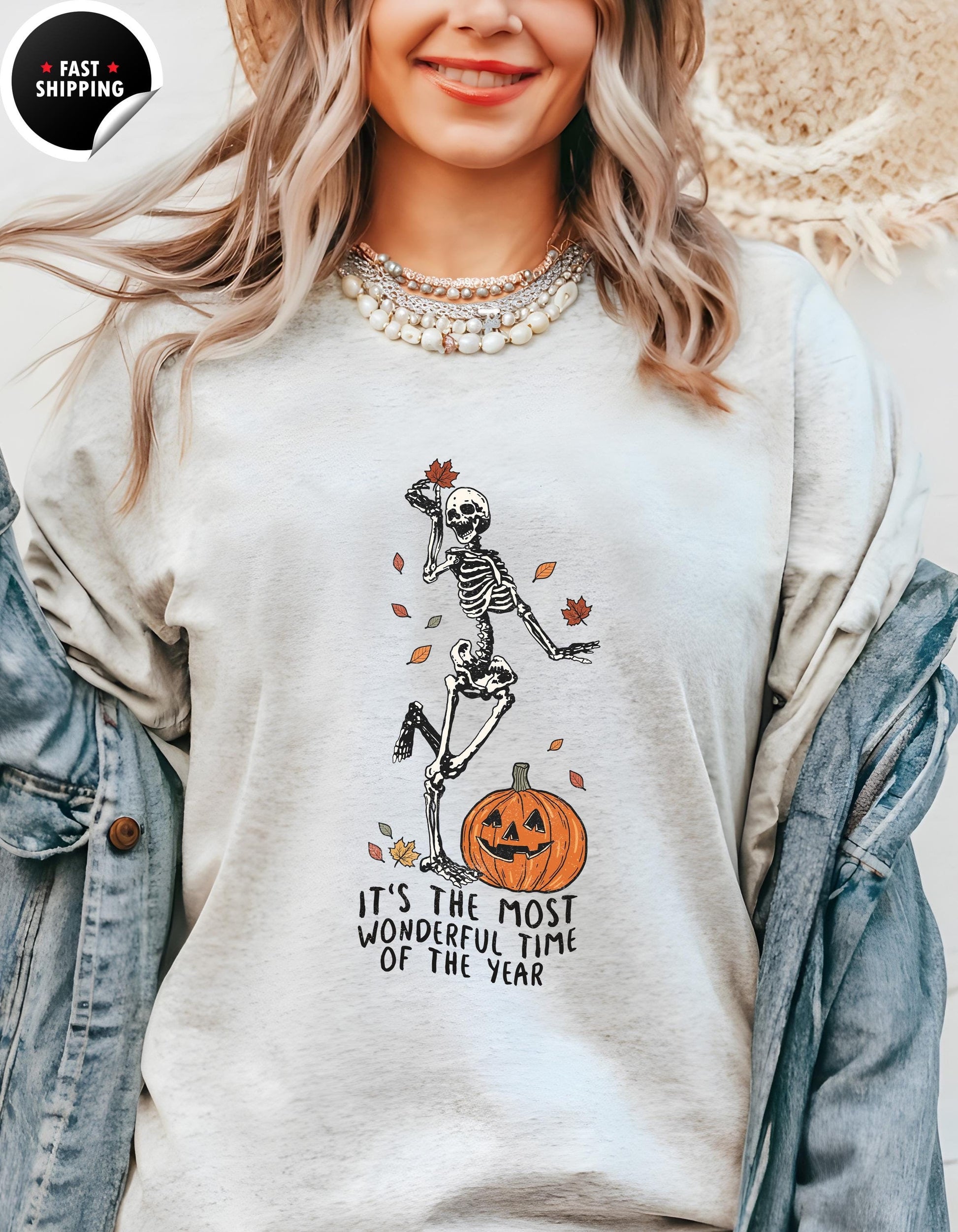 a woman wearing a white shirt with a skeleton on it