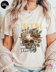 a woman wearing a t - shirt with a skull and flowers on it