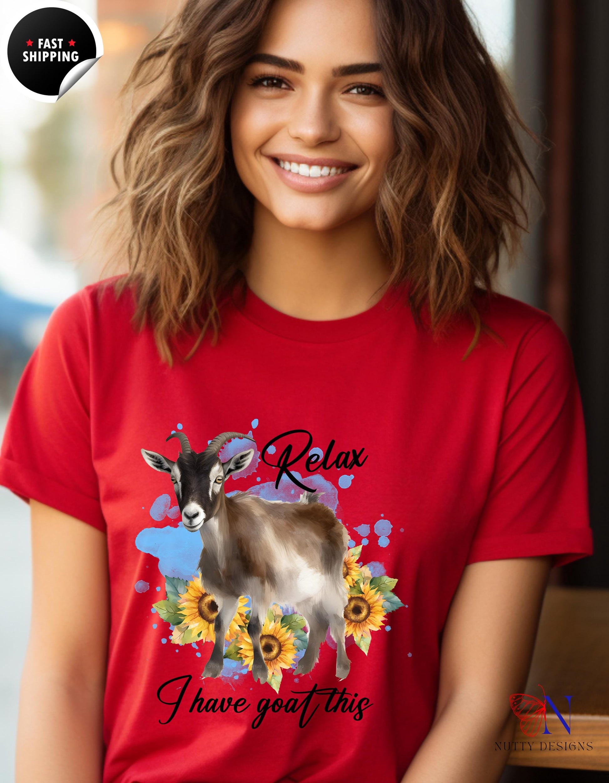 a woman wearing a red shirt with a cow on it