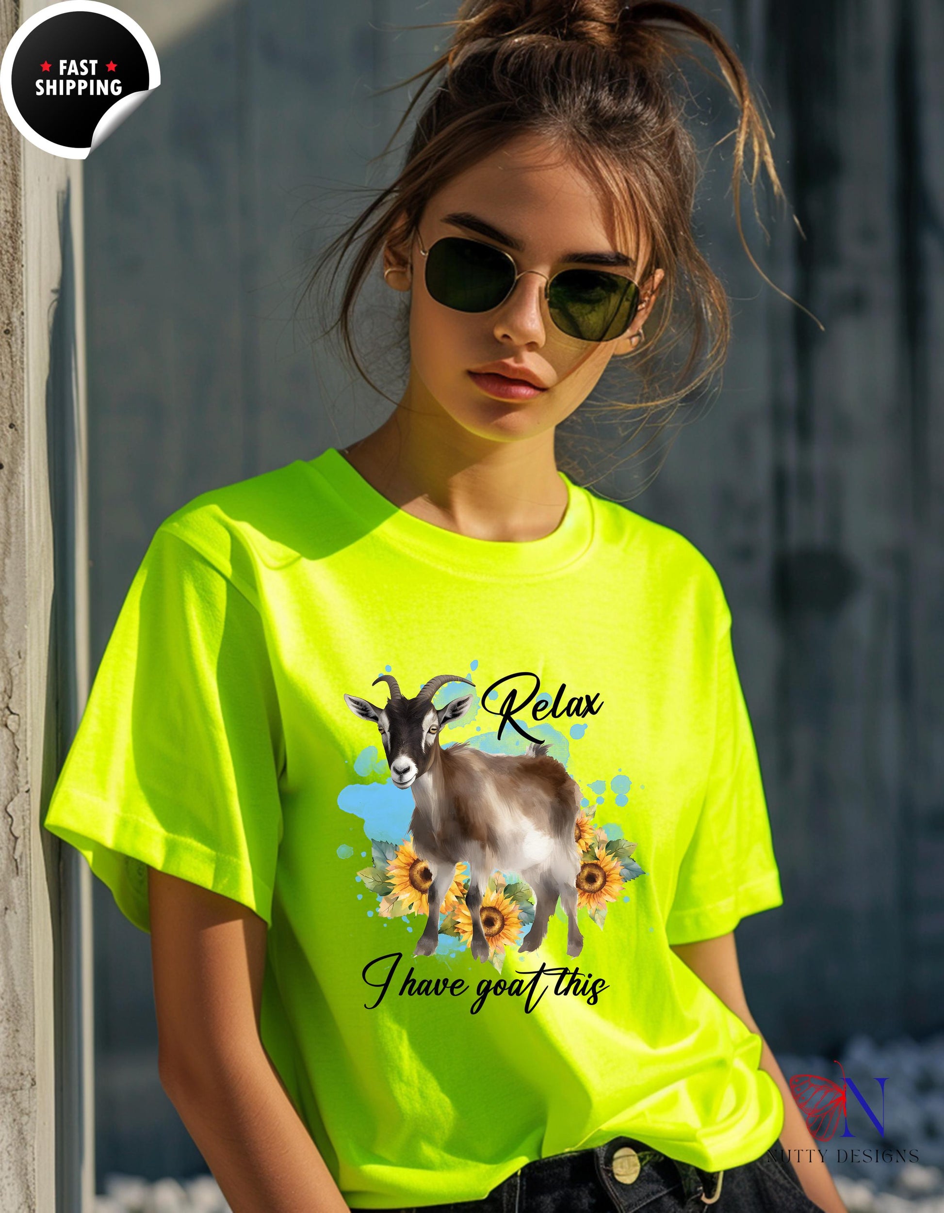 a woman wearing a yellow shirt with a goat on it