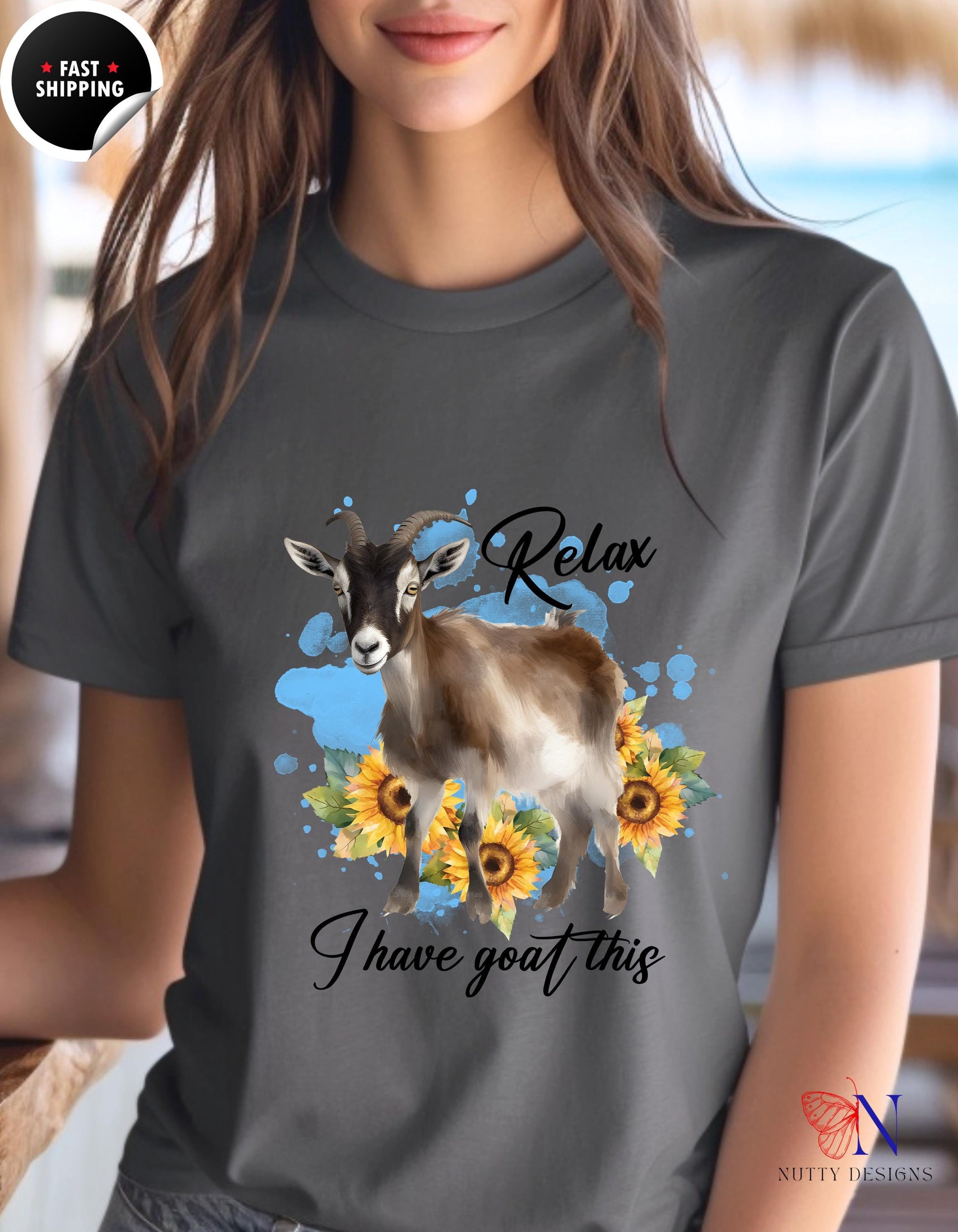 a woman wearing a t - shirt with a goat and sunflowers