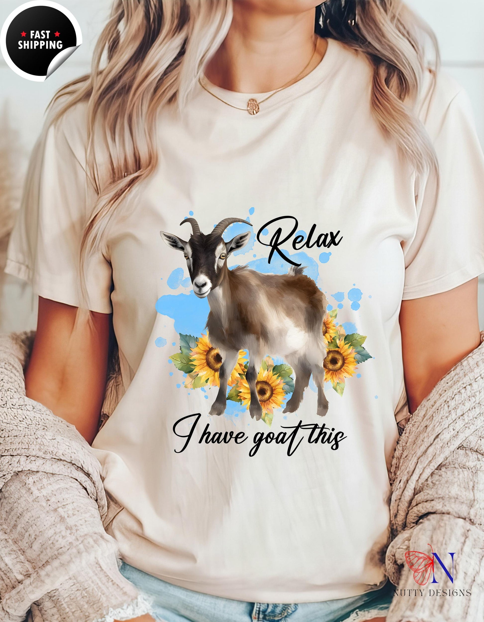 a woman wearing a t - shirt with a goat and sunflowers on it