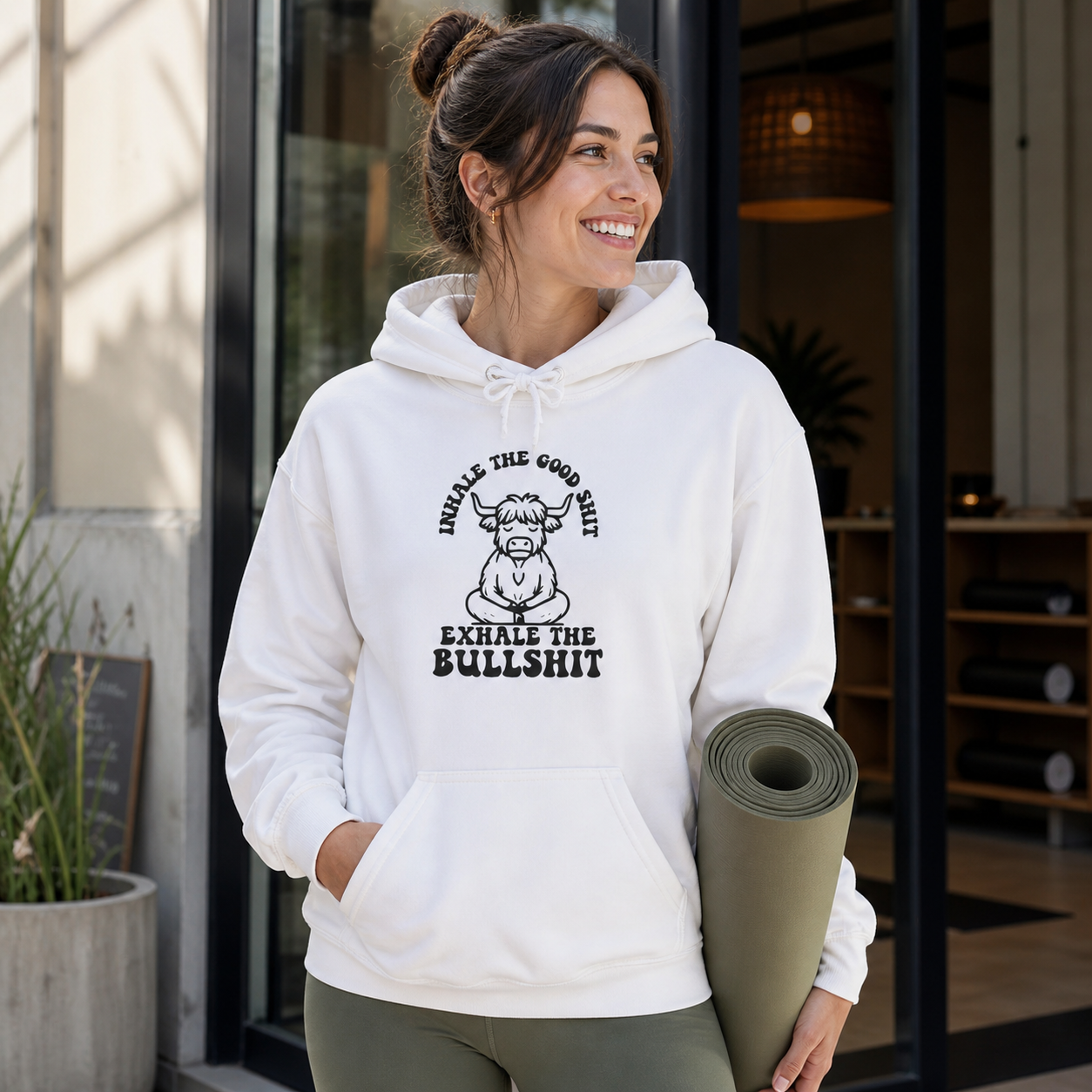 Woman wearing funny cow graphic hoodie in a casual outdoor lifestyle setting