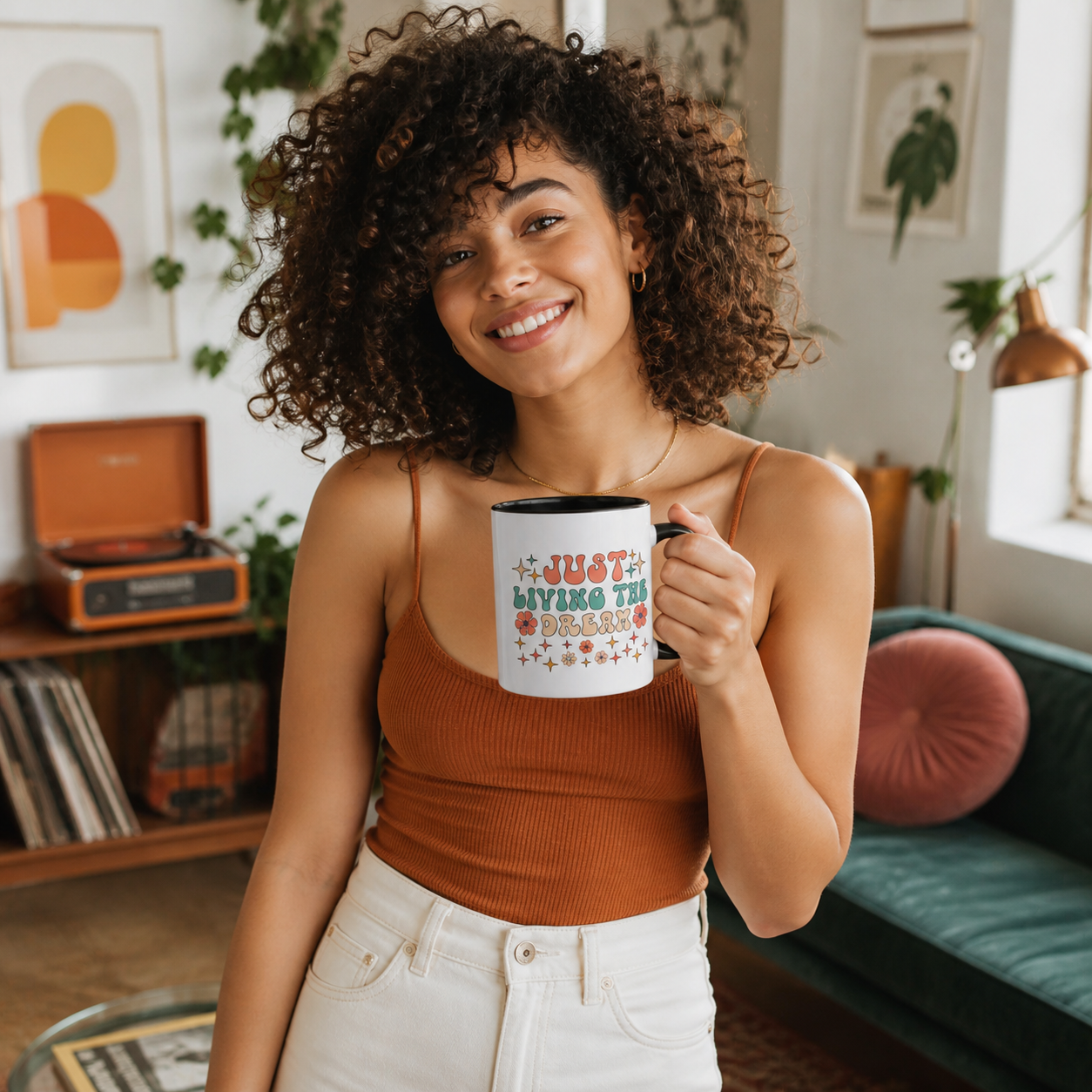 Young woman holding Just Living the Dream retro black-accent mug in a creative studio