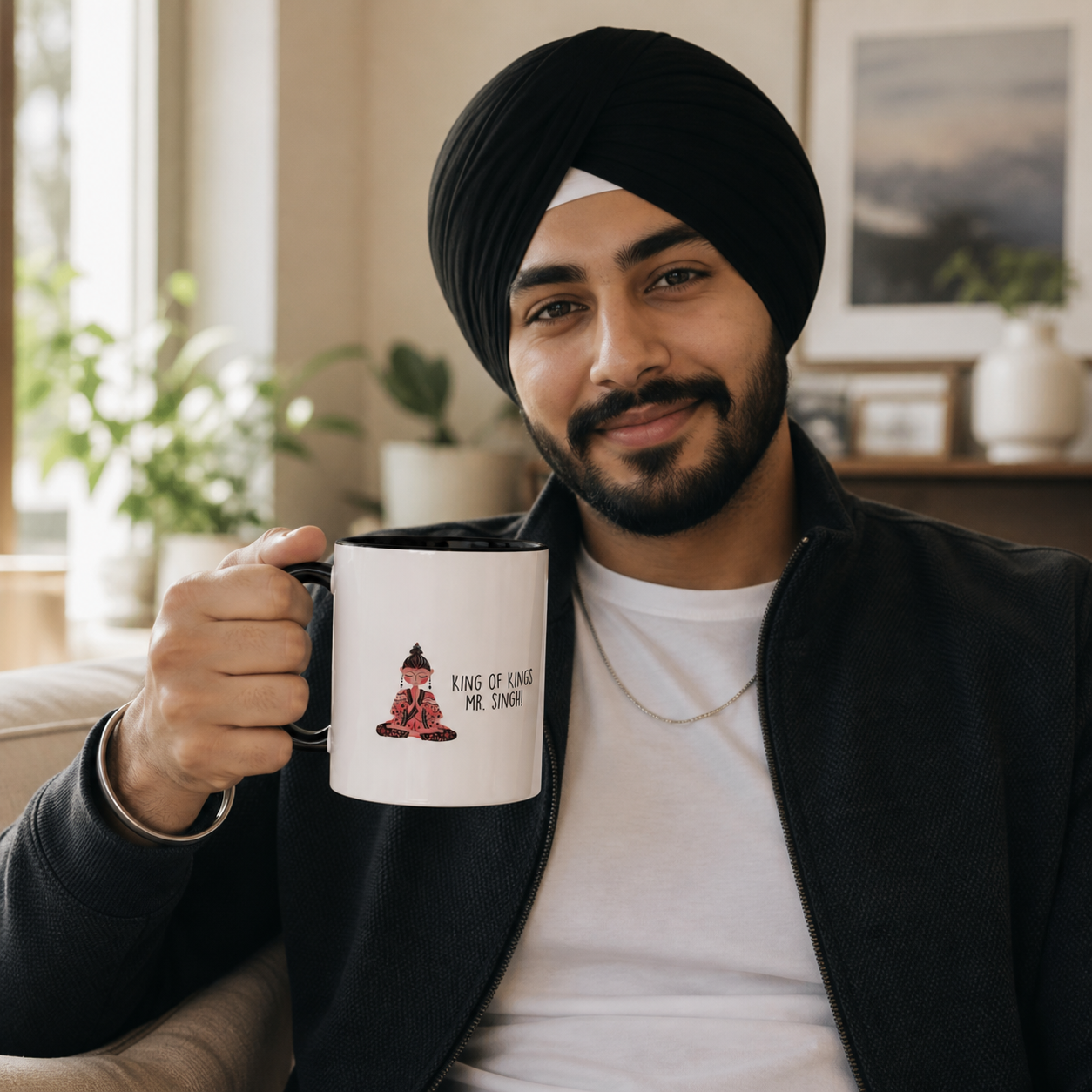 Young Sikh man holding black-accent King of Kings Mr Singh mug