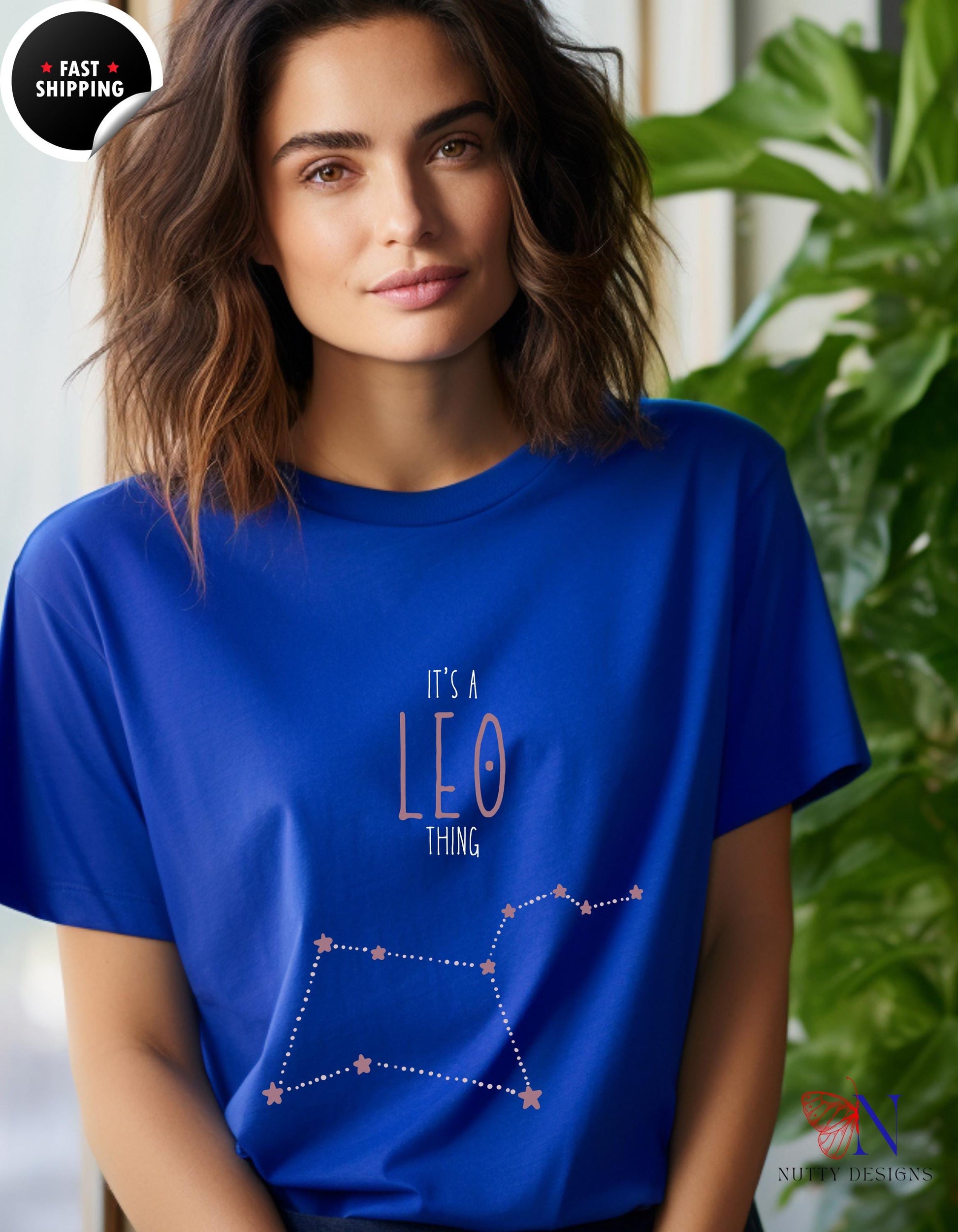 a woman wearing a blue shirt with the zodiac sign leo on it