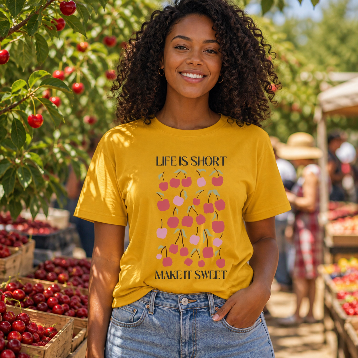 Young woman wearing Life Is Short Make It Sweet cherry graphic T-shirt at a farmers market
