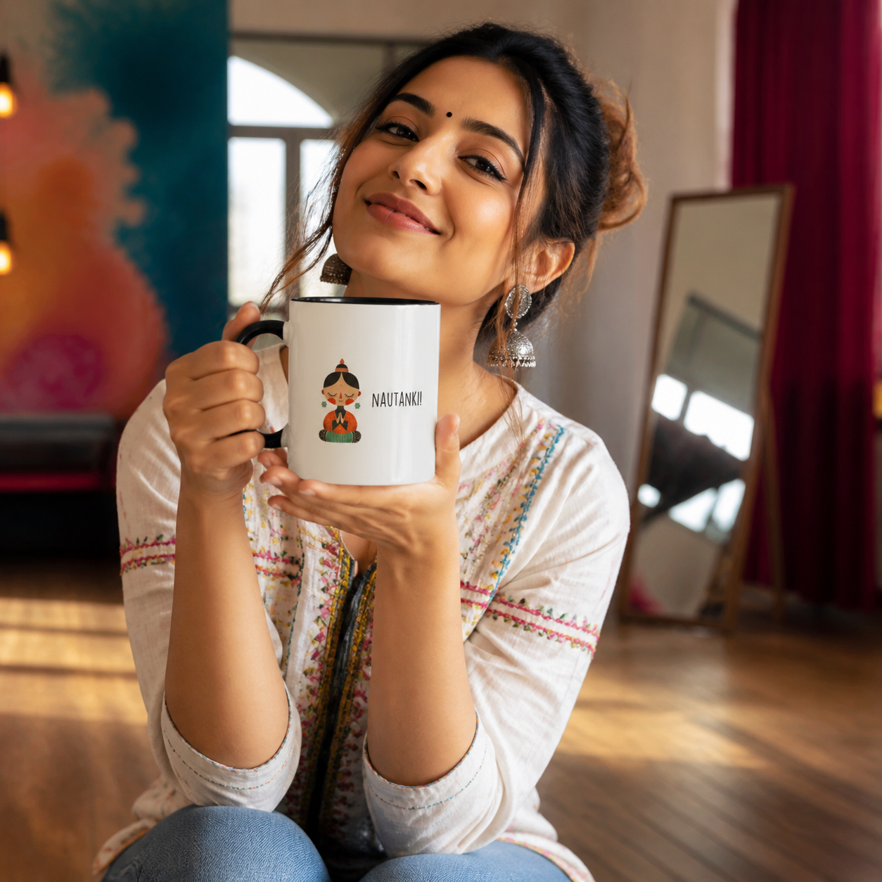 Young Indian woman holding black-accent Nautanki mug in a creative studio