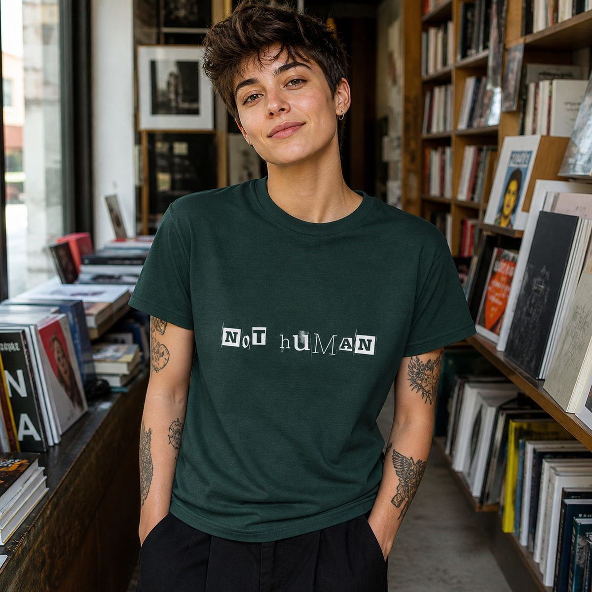 Young adult wearing Not Human ransom-letter graphic T-shirt in an indie art bookstore