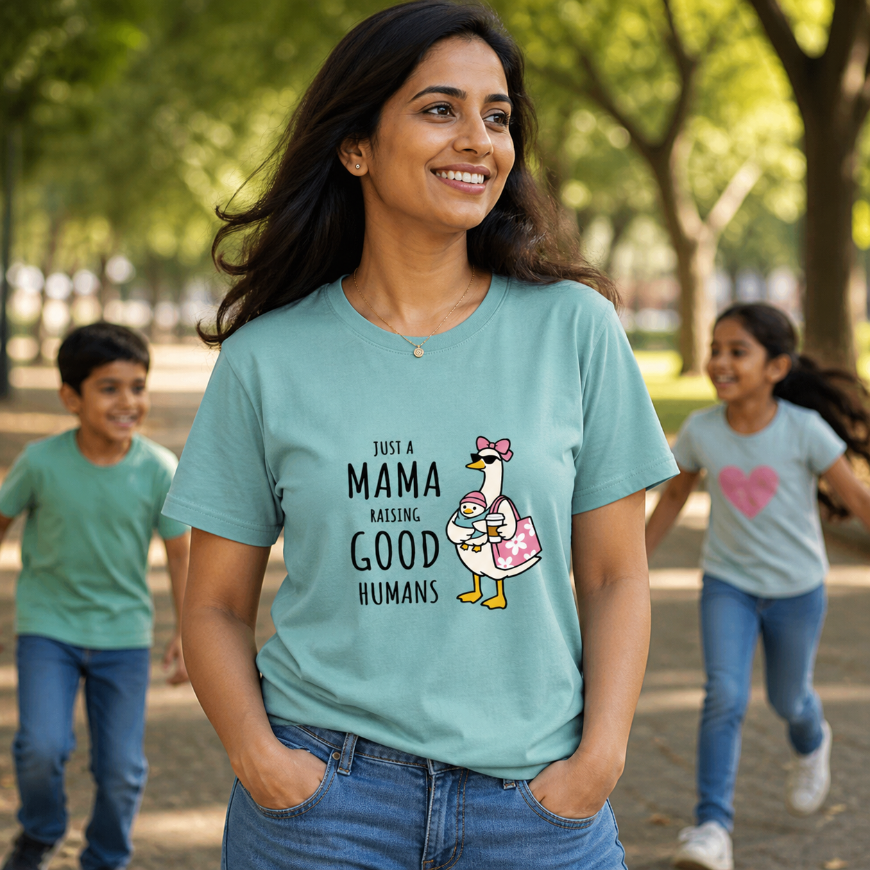 South Asian mom wearing Just a Mama Raising Good Humans T-shirt at a park