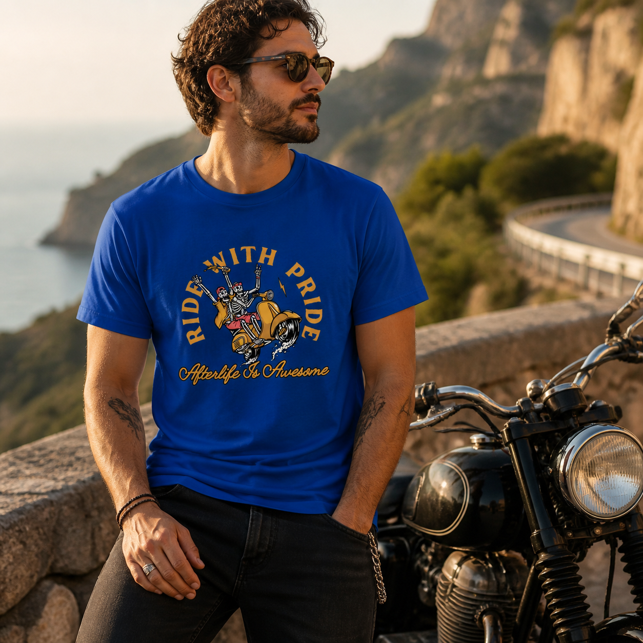 Young man wearing Ride With Pride skeleton motorcycle T-shirt beside a vintage motorcycle