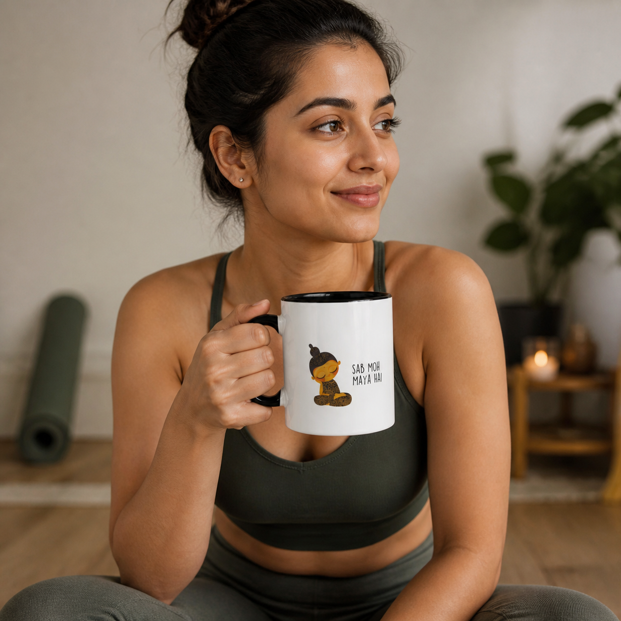 Young Indian woman holding black-accent Sab Moh Maya Hai mug after yoga