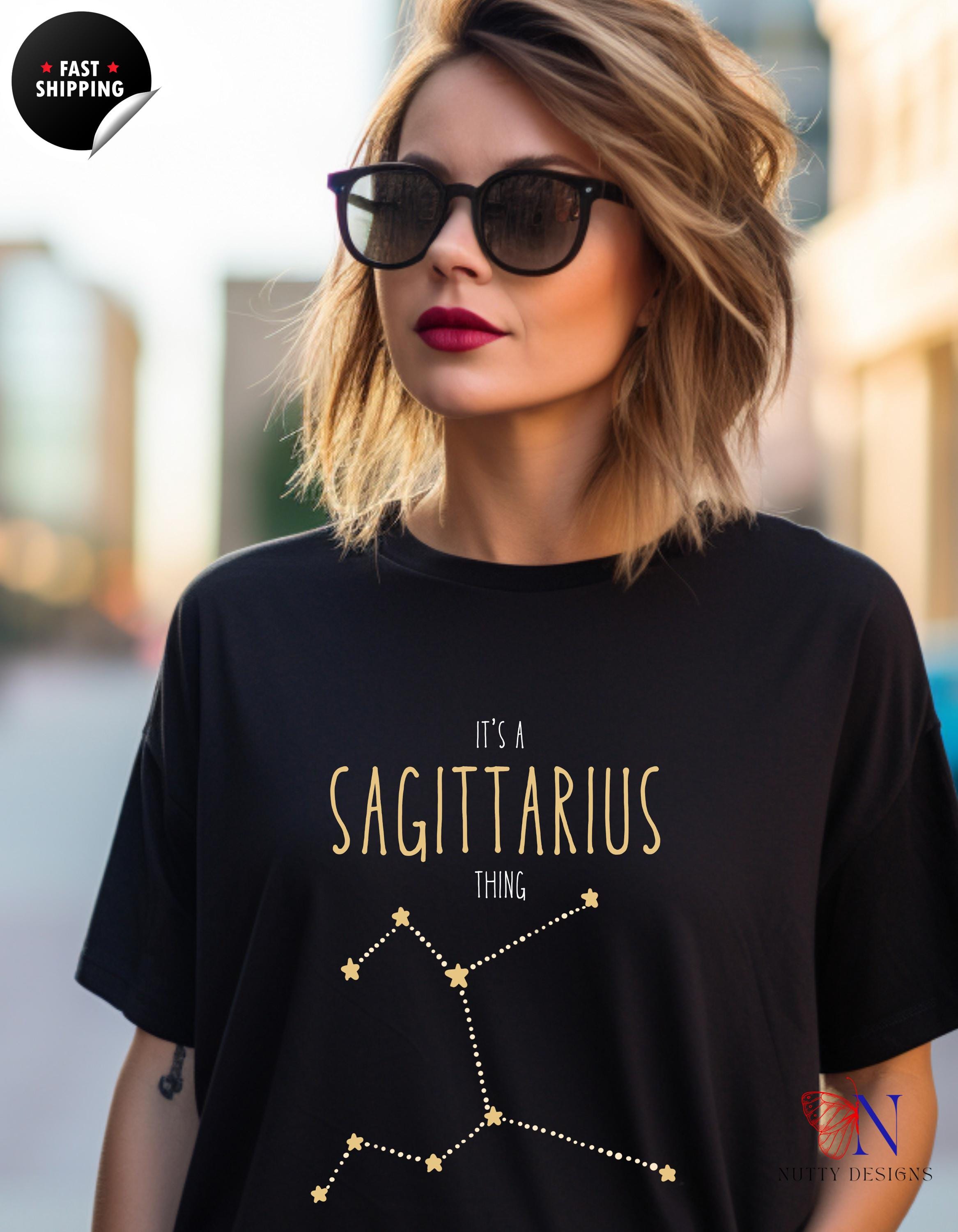 a woman wearing a black tshirt with a sagittarius t -