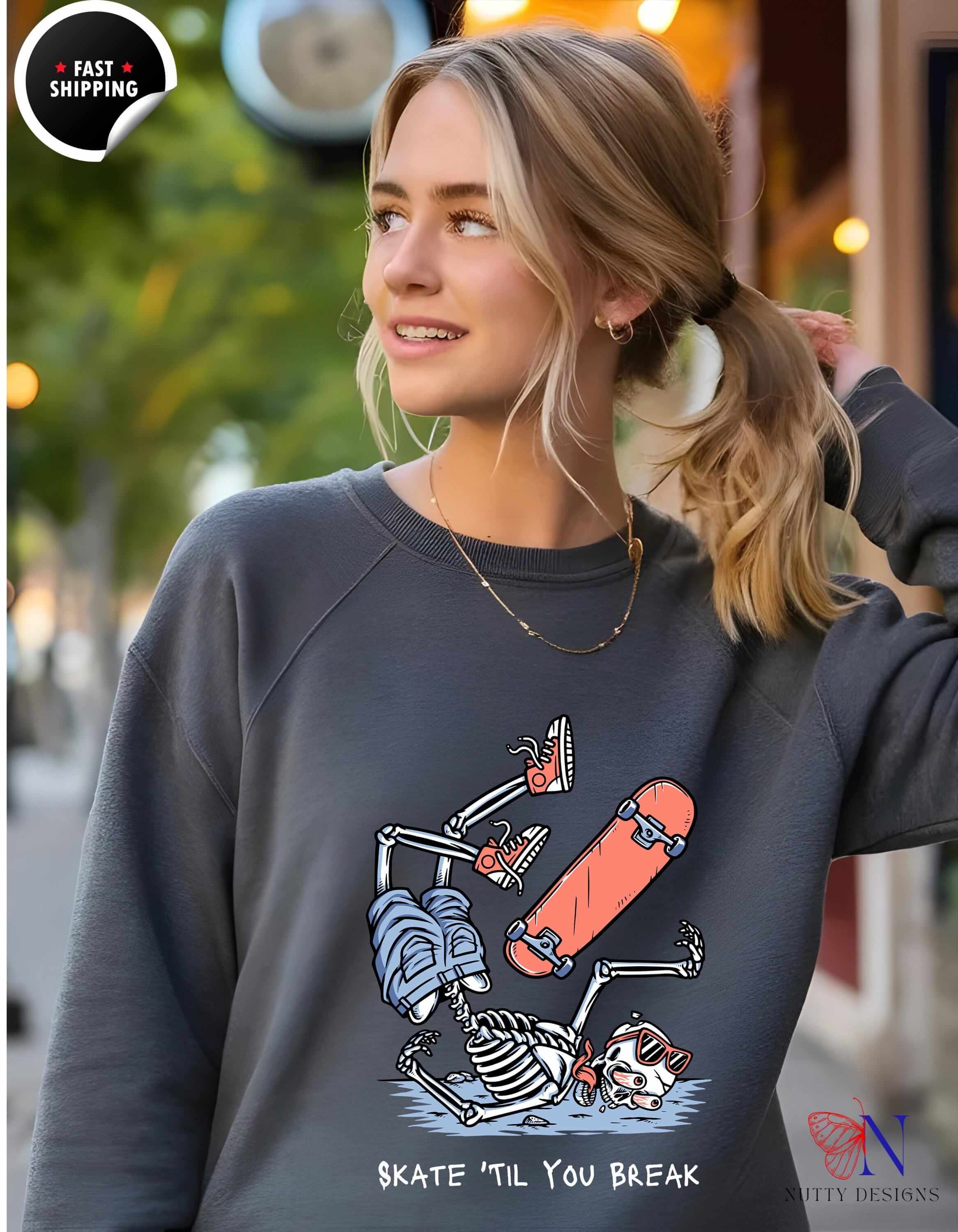 Funny skeleton sweatshirt design saying 'Skate 'til You Break', perfect for Halloween and casual wear.