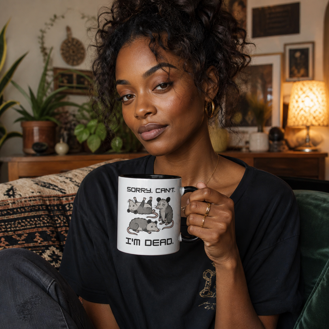 Young woman holding black-accent Sorry Can't I'm Dead opossum mug