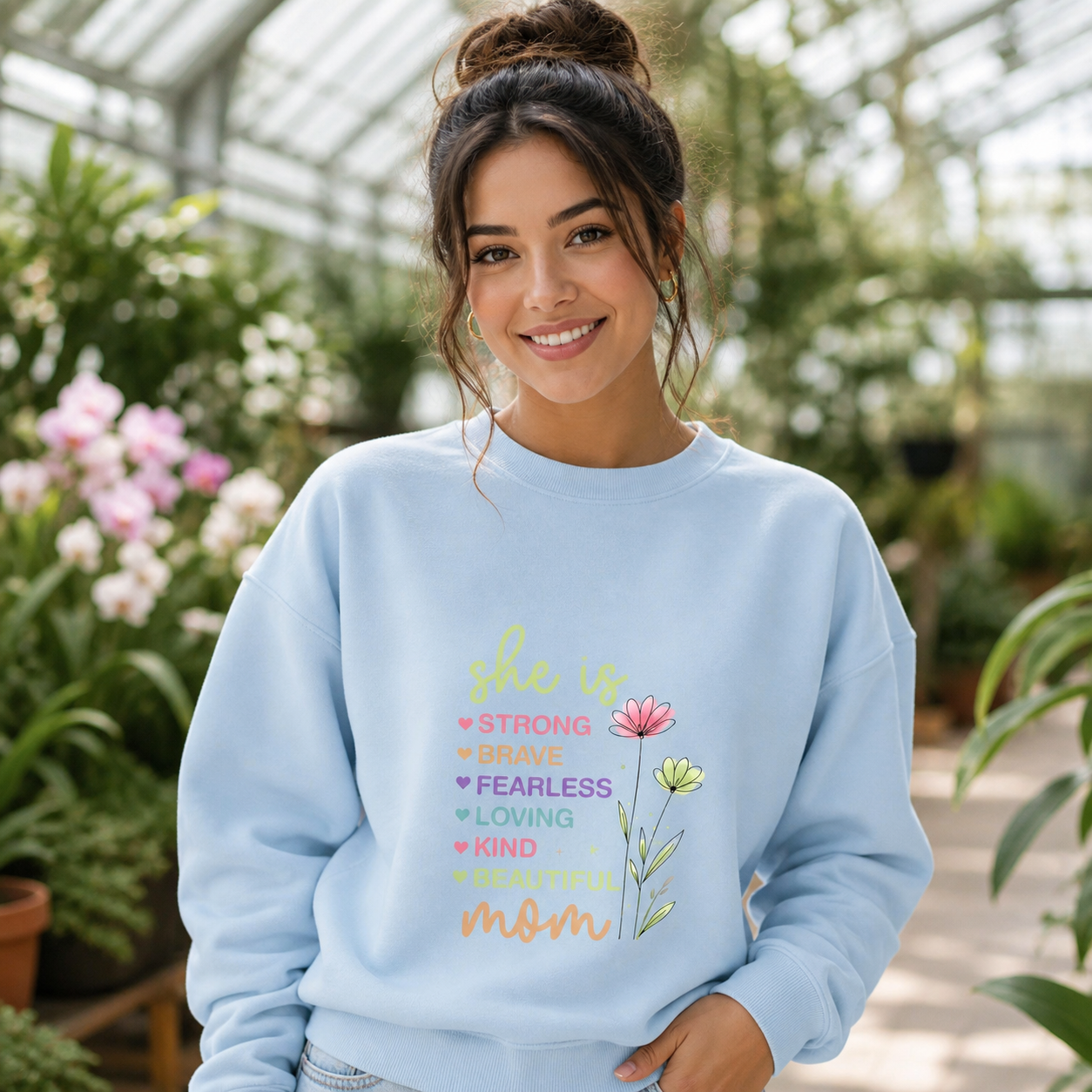Young mom wearing She Is Strong Brave Fearless floral crewneck sweatshirt
