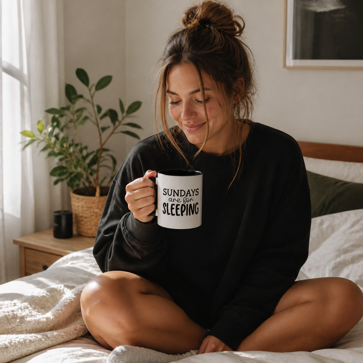Woman holding black accent Sundays Are for Sleeping coffee mug on a sunlit Sunday morning