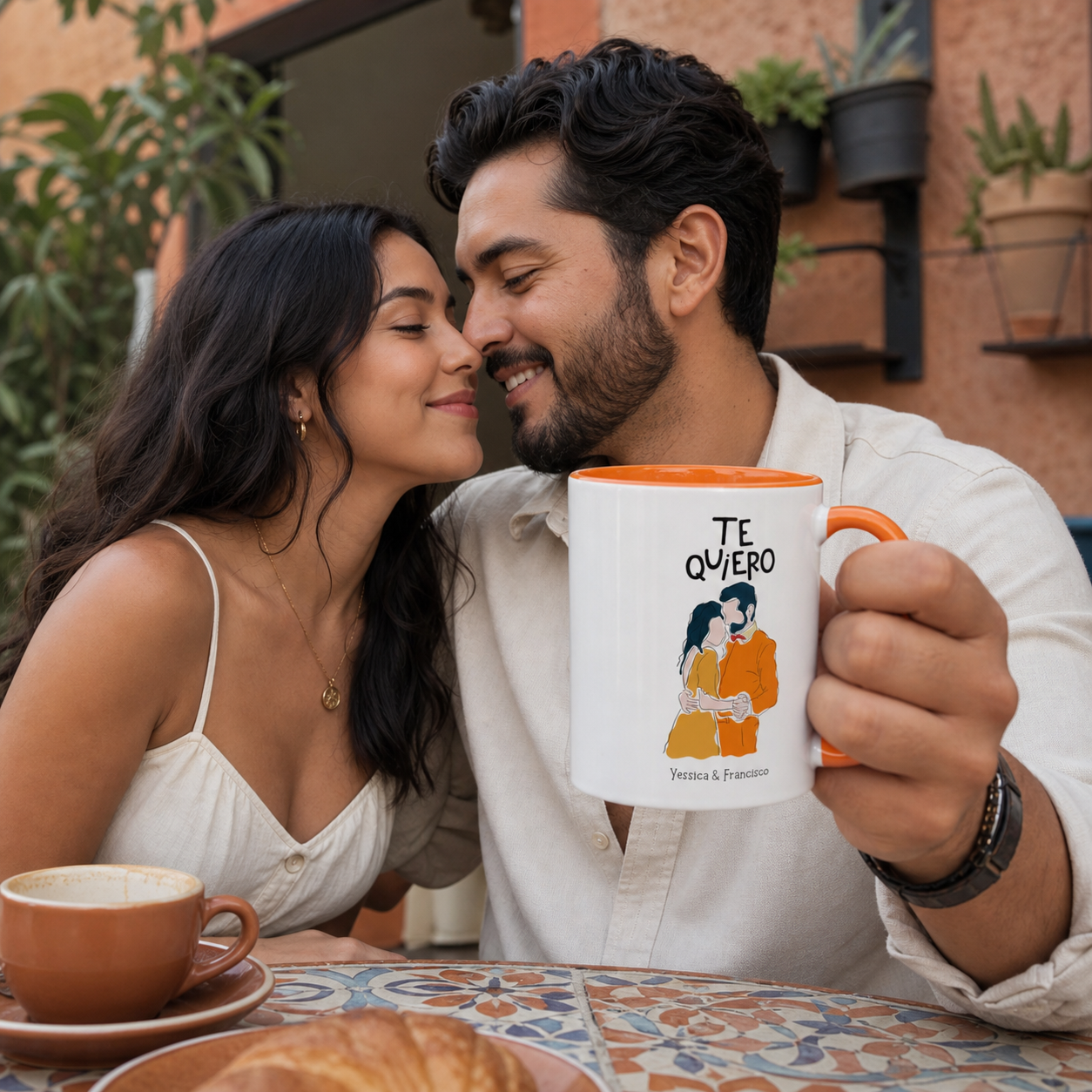 Young Latino couple holding personalized orange-accent Te Quiero mug at a cafe