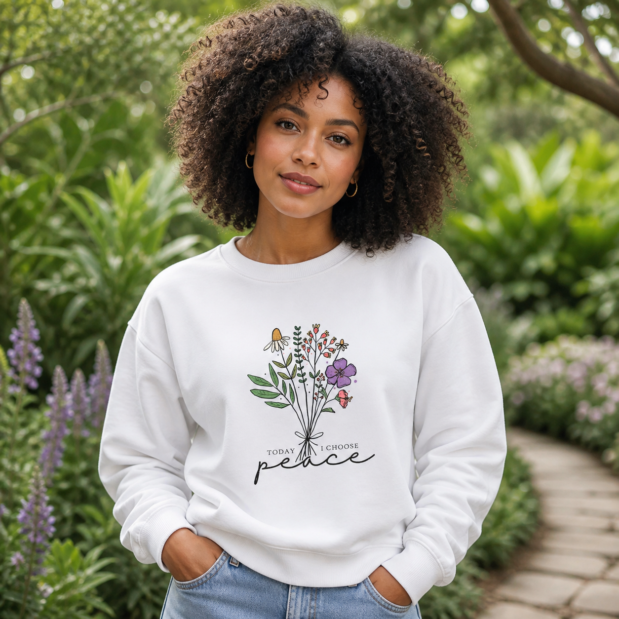 Young woman wearing Today I Choose Peace floral crewneck sweatshirt in a garden